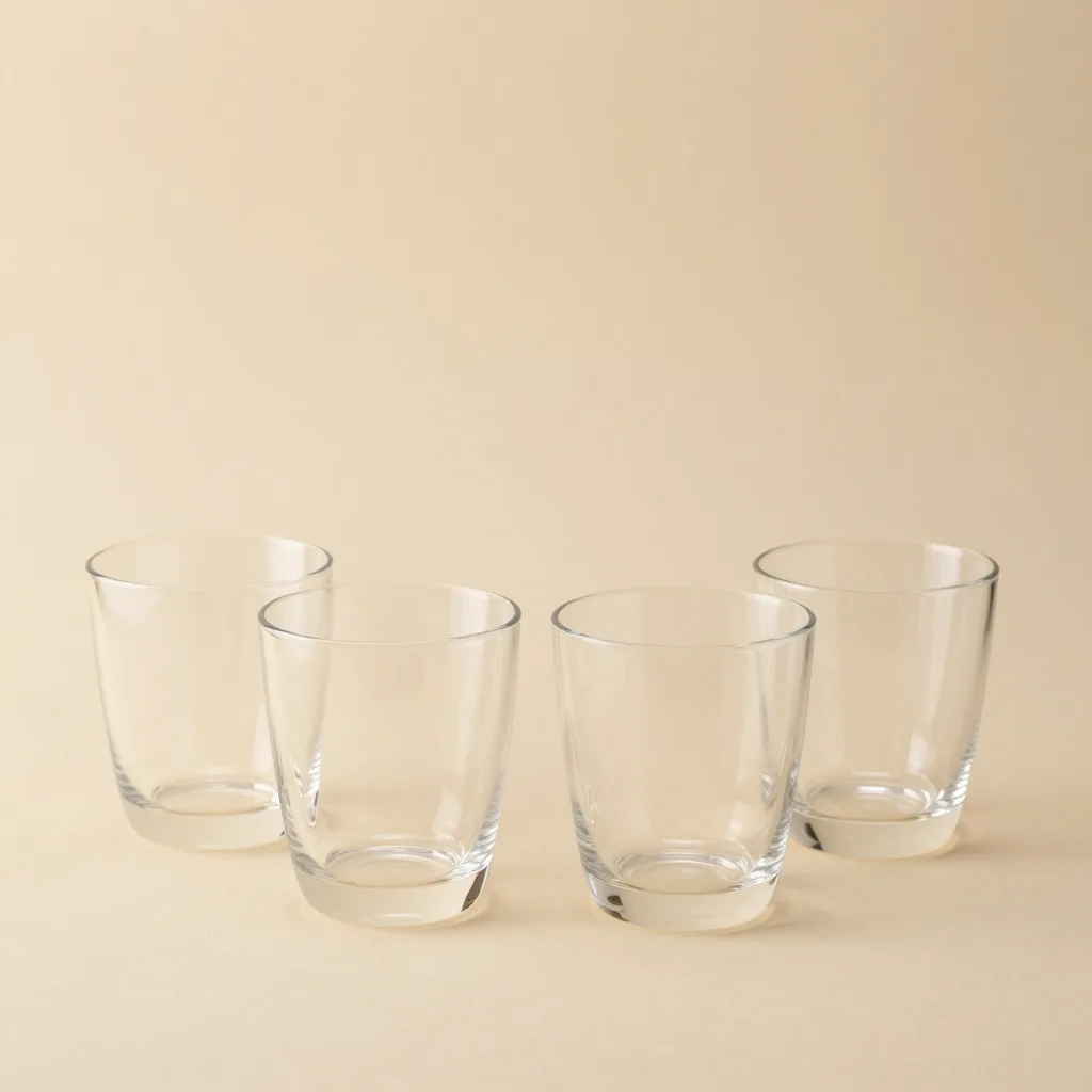 Four hand-blown Murano tumblers on a light background